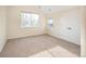 Empty bedroom with a large window, closet, and neutral carpet flooring at 2434 S Williams St, Denver, CO 80210
