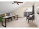 Bright bedroom featuring neutral carpet, desk, ceiling fan, and sliding door to balcony at 2434 S Williams St, Denver, CO 80210