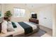 Well-lit bedroom with large window, closet, and a comfortable bed with a TV at 2434 S Williams St, Denver, CO 80210