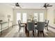 Dining area with a wood table, six chairs, two ceiling fans and natural light from French doors at 2434 S Williams St, Denver, CO 80210