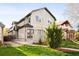 Charming two-story townhome featuring a well-maintained lawn and inviting curb appeal at 2434 S Williams St, Denver, CO 80210