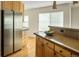 Bright kitchen featuring stainless steel refrigerator, wood cabinets and granite countertops and hardwood flooring at 2434 S Williams St, Denver, CO 80210