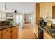 Spacious kitchen with hardwood floors leading to a living area with a fireplace and white armchairs at 2434 S Williams St, Denver, CO 80210