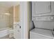 Bathroom featuring a stylish sink, vanity, a glass-enclosed shower, and in-unit laundry at 13732 E Lehigh Ave # H, Aurora, CO 80014