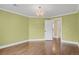 Spacious bedroom with hardwood floors, a chandelier, and open doorway at 13732 E Lehigh Ave # H, Aurora, CO 80014