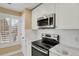 Clean kitchen featuring stainless steel appliances, marble countertops, and ample natural light at 13732 E Lehigh Ave # H, Aurora, CO 80014