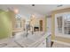 Modern kitchen view showcasing marble countertops, stainless appliances, and adjacent living area at 13732 E Lehigh Ave # H, Aurora, CO 80014