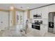 Updated kitchen featuring marble countertops, stainless steel appliances, and stylish pendant lighting at 13732 E Lehigh Ave # H, Aurora, CO 80014