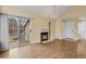 Inviting living room with a cozy fireplace, sliding glass doors, and a chandelier at 13732 E Lehigh Ave # H, Aurora, CO 80014