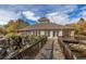 Beautiful backyard wooden bridge with a scenic view of a stream and lush landscaping at 13732 E Lehigh Ave # H, Aurora, CO 80014