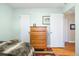 Bedroom with hardwood floors and an antique wooden dresser at 1432 Xanthia St, Denver, CO 80220