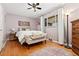 Bright bedroom with hardwood floors, a comfortable bed, and neutral decor at 1432 Xanthia St, Denver, CO 80220