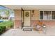 Inviting front porch featuring a chair, decorative wreath, and address for a welcoming appeal at 1432 Xanthia St, Denver, CO 80220