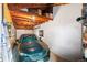 Garage interior featuring exposed ceiling beams, a car, and shelving for storage at 1432 Xanthia St, Denver, CO 80220