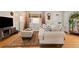 Cozy living room with a large patterned rug, comfortable couch, and modern entertainment center at 1432 Xanthia St, Denver, CO 80220