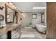 Bathroom with tub, shower, and custom wood accents at 1654 Muirfield Ln, Evergreen, CO 80439