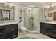 Bathroom featuring corner shower with dual sinks and mirrors at 1654 Muirfield Ln, Evergreen, CO 80439