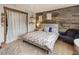Bedroom features a wood accent wall and eclectic decor at 1654 Muirfield Ln, Evergreen, CO 80439