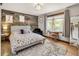 Bedroom features a wood accent wall and eclectic decor at 1654 Muirfield Ln, Evergreen, CO 80439
