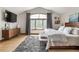 Bedroom with large window, wood floors, and gray shag rug at 1654 Muirfield Ln, Evergreen, CO 80439