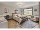 Cozy bedroom features a wooden bed frame, a light colored rug and a work space with a desk at 1654 Muirfield Ln, Evergreen, CO 80439