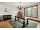 This dining room has a rustic wooden table and chairs and a nice view out the picture window at 1654 Muirfield Ln, Evergreen, CO 80439
