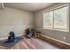 Basement exercise room features hardwood floors, recessed lights, a window, and exercise equipment at 1654 Muirfield Ln, Evergreen, CO 80439