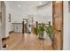 Upper hallway with wood floors, iron railings, chandelier and a glimpse of the kitchen area at 1654 Muirfield Ln, Evergreen, CO 80439