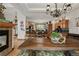 Open floor plan with kitchen island, wood cabinets, black countertop, and views into the living room and dining area at 1654 Muirfield Ln, Evergreen, CO 80439
