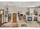 Open-concept living room flows into the dining area and kitchen featuring hardwood floors at 1654 Muirfield Ln, Evergreen, CO 80439
