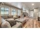 Basement living room featuring hardwood floors, recessed lights, large sofa and a staircase at 1654 Muirfield Ln, Evergreen, CO 80439