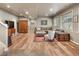Well lit basement living room with hardwood floors, recessed lighting, and comfortable furniture at 1654 Muirfield Ln, Evergreen, CO 80439