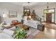 Inviting living area with hardwood floors, a fireplace, and staircase at 1654 Muirfield Ln, Evergreen, CO 80439