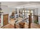 Open-concept living space with staircase, fireplace, dining area, and large windows offering plenty of natural light at 1654 Muirfield Ln, Evergreen, CO 80439