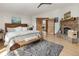 The main bedroom has a stone fireplace, ceiling fan and wood sliding doors leading to the hallway at 1654 Muirfield Ln, Evergreen, CO 80439