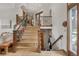 A bright and inviting staircase with wood banisters and wrought iron spindles offers access to the upper level at 1654 Muirfield Ln, Evergreen, CO 80439