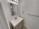 Modern powder room featuring a new vanity, sink, and updated fixtures at 11422 W 17Th Pl, Lakewood, CO 80215