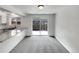 Dining Room area with walkout patio doors, next to the kitchen with granite counters at 11422 W 17Th Pl, Lakewood, CO 80215