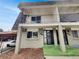 Townhouse exterior with a private balcony, covered parking, and well-maintained landscaping at 11422 W 17Th Pl, Lakewood, CO 80215
