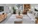 Bright, staged living room featuring modern furniture, neutral colors, and ample natural light at 11422 W 17Th Pl, Lakewood, CO 80215