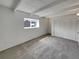 Empty main bedroom with an ensuite bathroom, large window, beamed ceilings, and spacious closet at 11422 W 17Th Pl, Lakewood, CO 80215