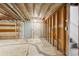 Unfinished basement with storage shelving and a door at 12573 W 8Th Ave, Golden, CO 80401