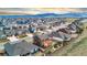 Panoramic aerial view showcasing a large neighborhood with the majestic mountains in the background on a sunny day at 18267 W 95Th Ave, Arvada, CO 80007