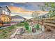 Cozy backyard with two green Adirondack chairs around stone at 18267 W 95Th Ave, Arvada, CO 80007
