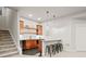 Finished basement bar with elegant cabinets, bar seating and stairs to the upper level at 18267 W 95Th Ave, Arvada, CO 80007