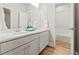 Clean bathroom with dual vanity, white cabinets and walk-in shower at 18267 W 95Th Ave, Arvada, CO 80007