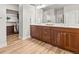 Stylish bathroom featuring dual sinks, wood cabinets and walk-in closet at 18267 W 95Th Ave, Arvada, CO 80007