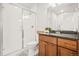 Bright bathroom featuring a glass-enclosed shower and patterned tile floors at 18267 W 95Th Ave, Arvada, CO 80007
