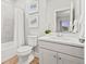 Well-lit bathroom with white vanity, wood floors, and bathtub with shower at 18267 W 95Th Ave, Arvada, CO 80007