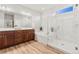 Bright bathroom with double vanity, soaking tub, and glass enclosed shower with marble style at 18267 W 95Th Ave, Arvada, CO 80007